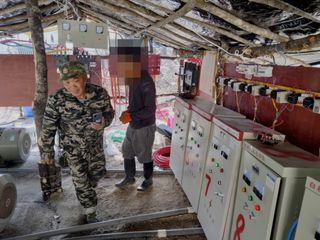Workers operate Chinese-made machinery at a rare earth mine in Myanmar's Kachin State
