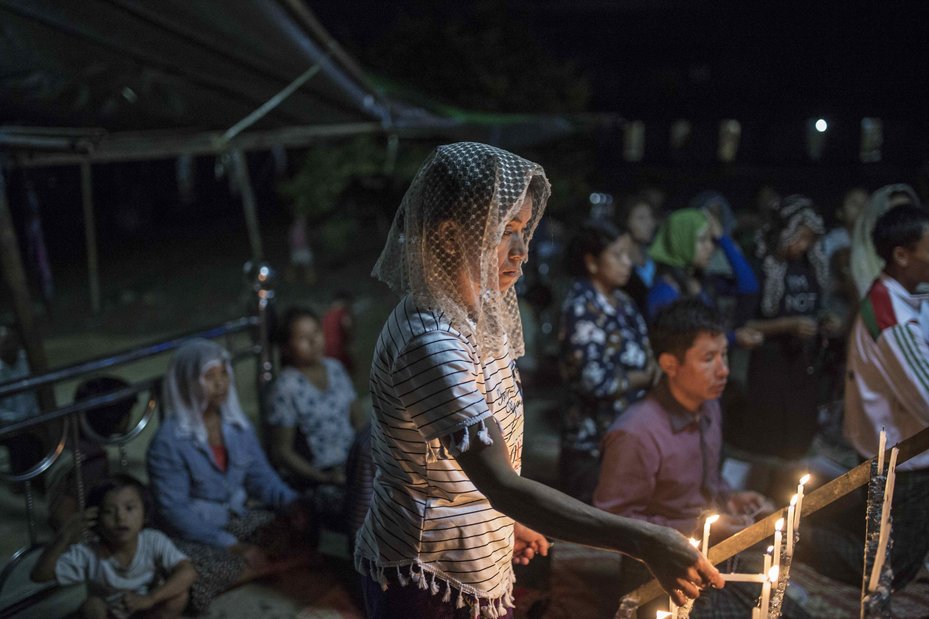 Internally displaced people say prayers in the evening at the Namt Ma-Phyit Roman-Catholic IDP camp which is home to displaced villagers from villages in and around Hpakant, October 26, 2016.