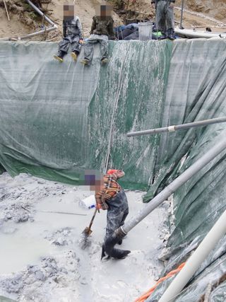 Rare earth miners work at a collection pool in Kachin State, Myanmar